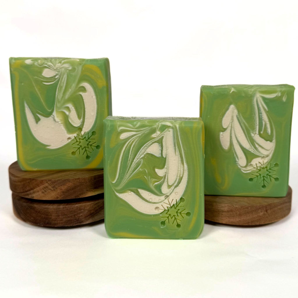 Swirly Twirly Suds handmade Christmas soap with green, yellow and white swirls and snowflake decoration.
